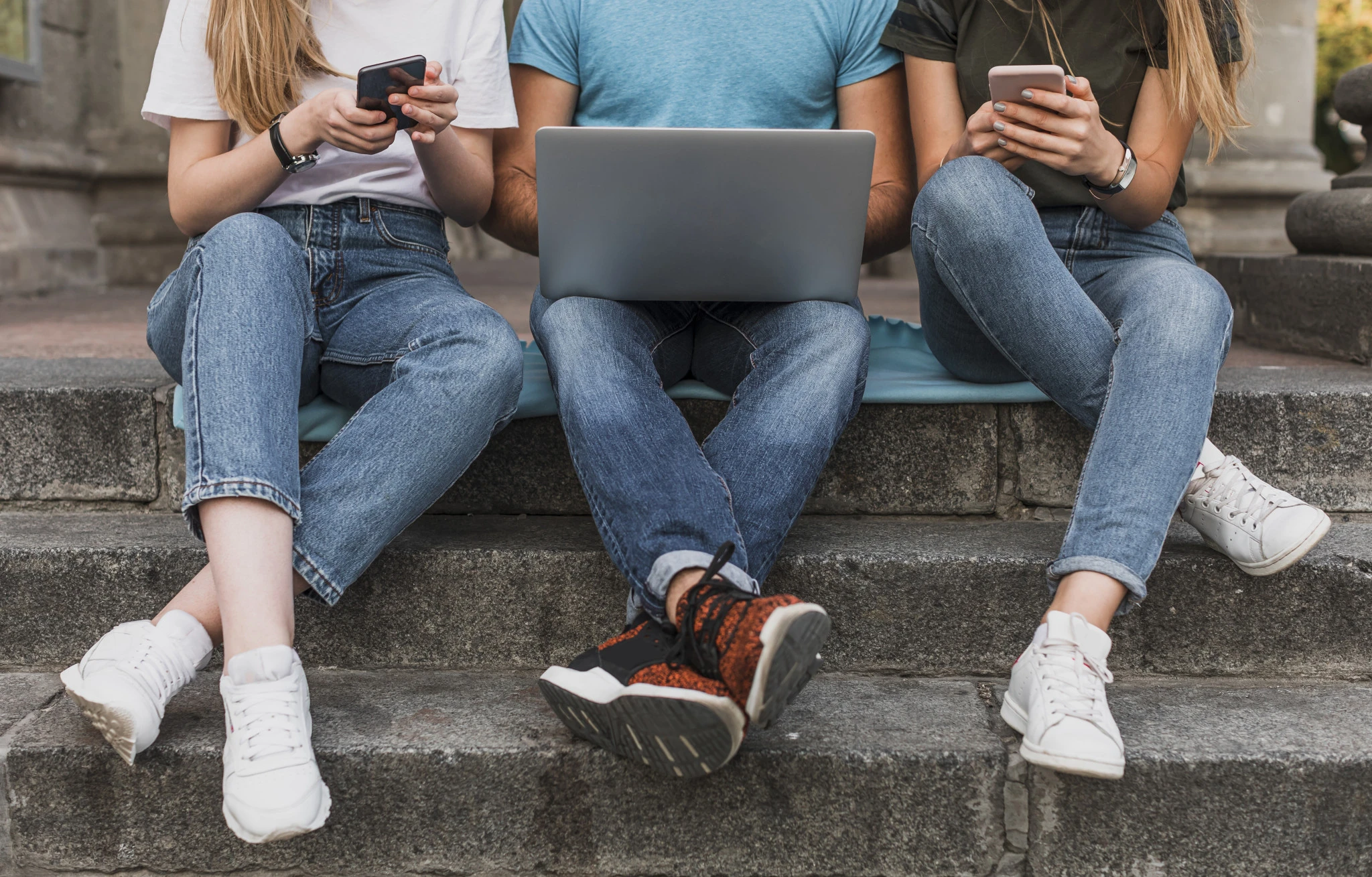 teens-sitting-stairs-working-phones-laptop.jpg